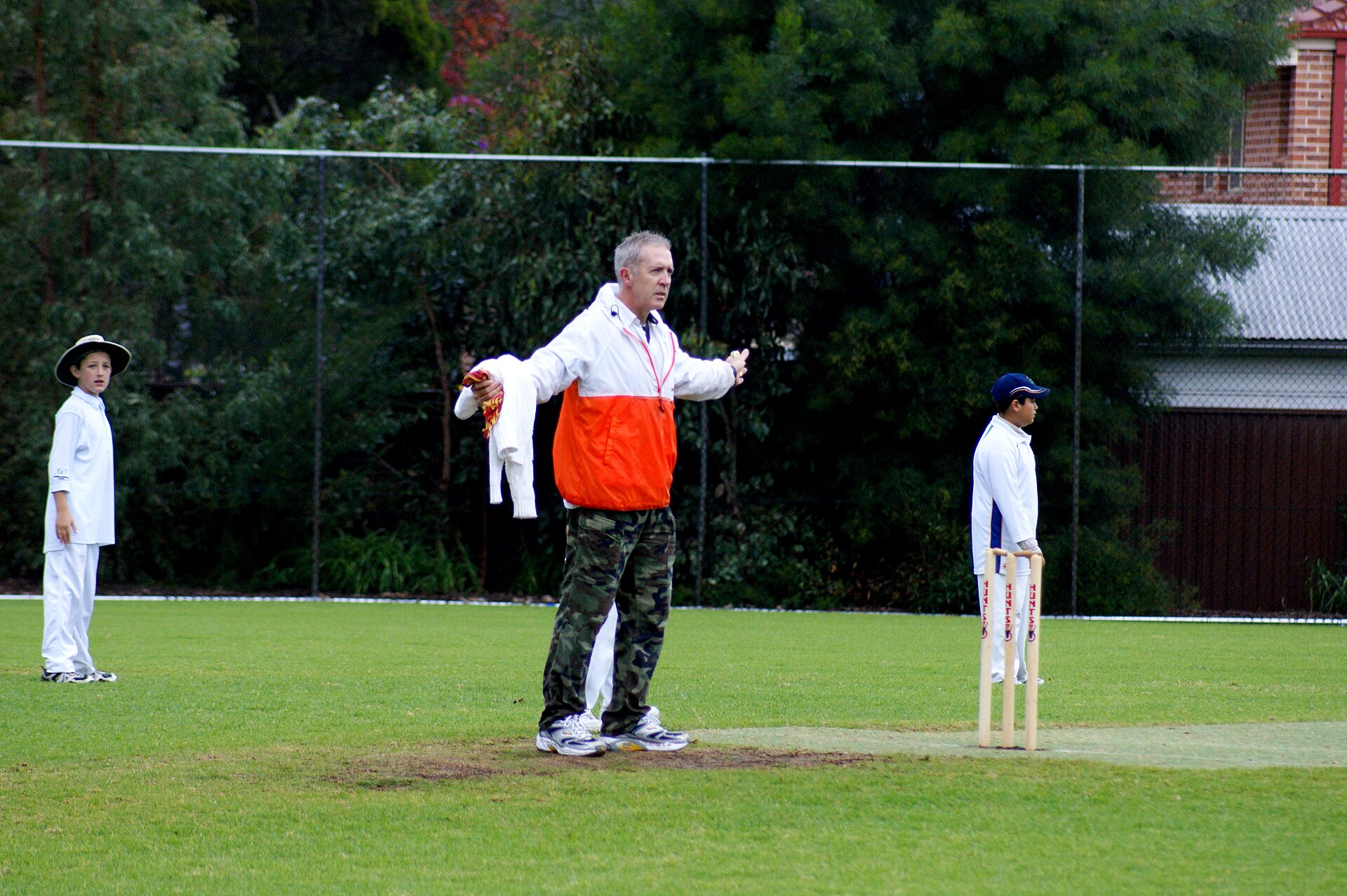 Umpire signalling a wide